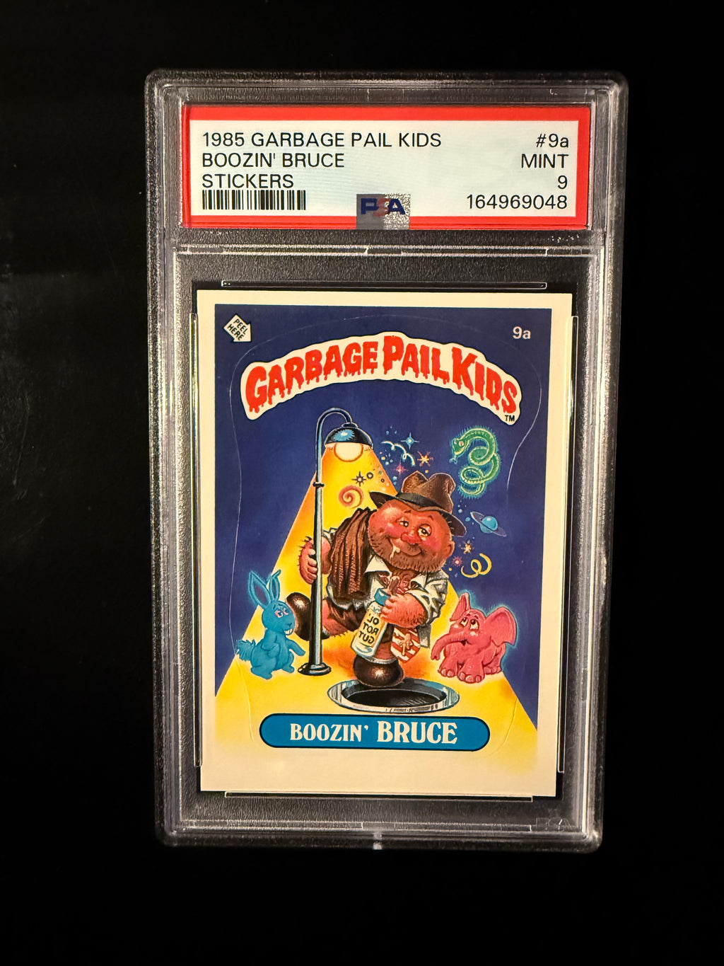 1985 Garbage Pail Kids #9a Boozin’ Bruce – PSA 9 Mint – Series 1 Original Sticker